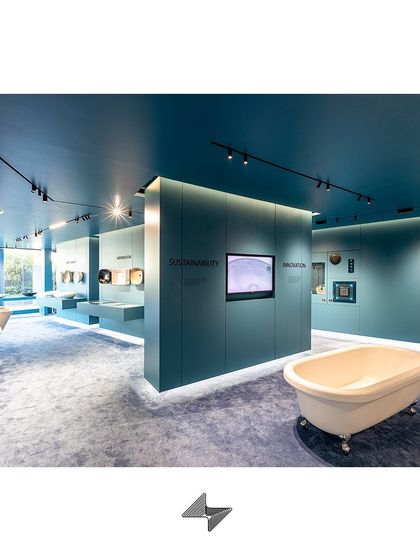 The strategic use of track lighting and ambient glow from below the display walls creates layers of light, adding depth and sophistication to the retail interior.