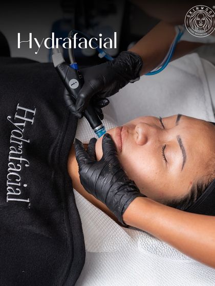 A client receiving a HydraFacial. This treatment is a favorite for festive prep, offering a deep cleanse and hydration boost for a fresh, camera-ready glow in just 30 minutes.