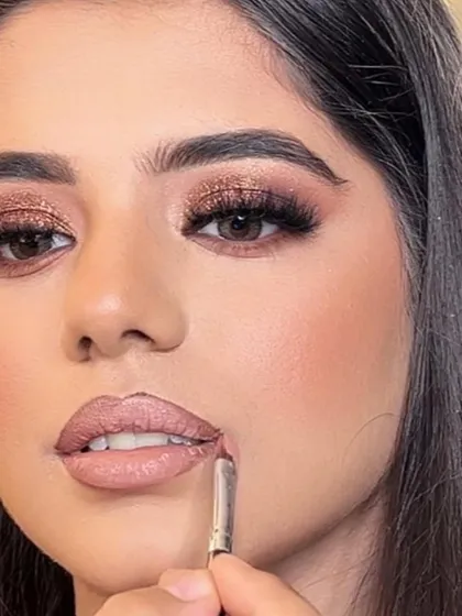 A close-up shot of the makeup process. Here, I'm carefully defining the lips, a crucial step for a polished and long-lasting lip color.