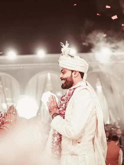A beautiful, candid moment of the couple greeting each other with a 'namaste' during the ceremony.