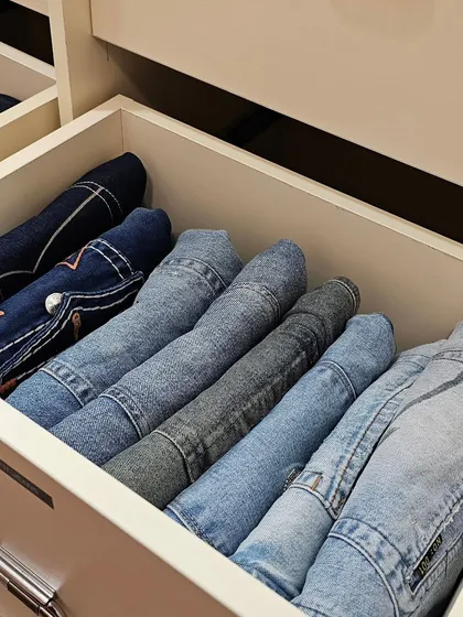 Stop stacking and start file-folding. This technique for folding jeans in a drawer allows you to see every pair at a glance, making it simple to pick what you want to wear without making a mess.