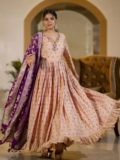 This shot captures the Anarkali gown in a graceful twirl. The movement beautifully displays the flare of the dress and the flow of the fabric, adding a dynamic element to the lookbook.