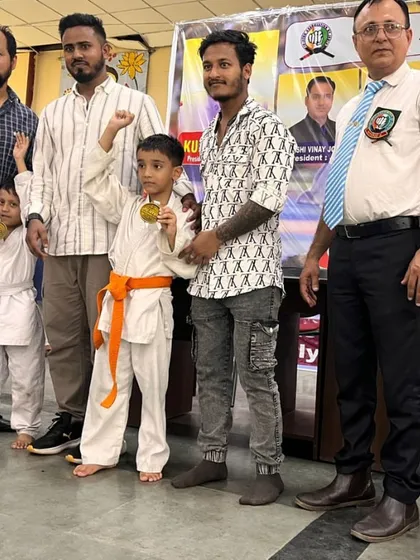 Posing with my young champions and their medals. Their success is my success. I train them to be fearless and to always aim for the top.