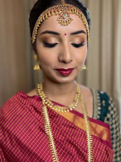 A close-up of Manasa's eye makeup. The soft gold shimmer and defined liner create a look that is both elegant and festive.