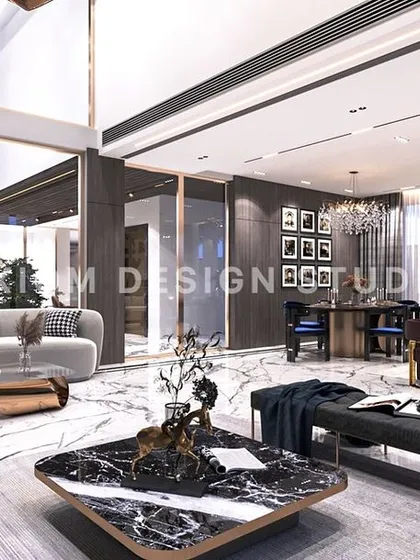 An overview of the double-height space, showing the relationship between the living area, dining zone, and the upper-level gallery.