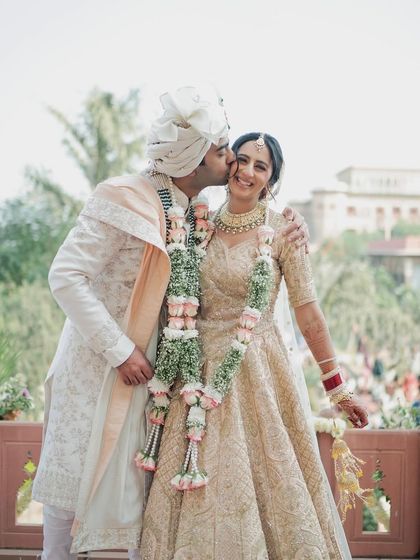 A sweet moment between the newlyweds. The bride's hair is elegantly styled, allowing for these beautiful, candid shots.