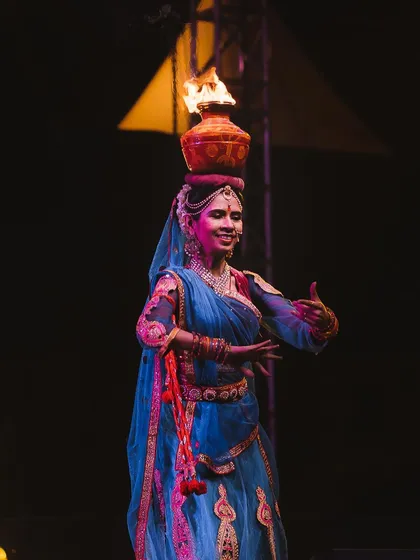 A performer balances a pot of fire on her head during a cultural dance. Capturing the intensity and skill of artists in challenging low-light situations is what I do best, freezing the peak of the action.