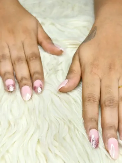A delicate ombre effect with a natural pink base fading into sparkling rose gold glitter at the tips.
