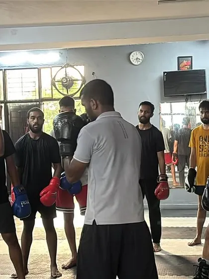 Sharpening the fundamentals with the group. I am demonstrating a defensive posture while students observe, ready to practice. This focus on technical detail is central to our training philosophy.