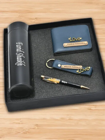 A sophisticated corporate gift set containing a personalized temperature bottle, a matching blue wallet and keychain set, and a name-engraved pen, all presented in a custom-fit box.
