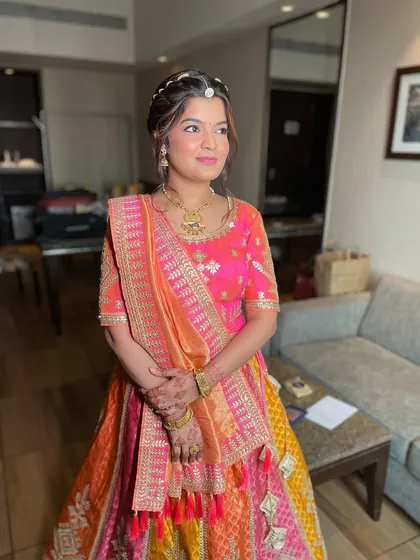 The complete look with the Gotapatti braid. The bride looks radiant and ready for her mehendi celebrations in her colorful lehenga.