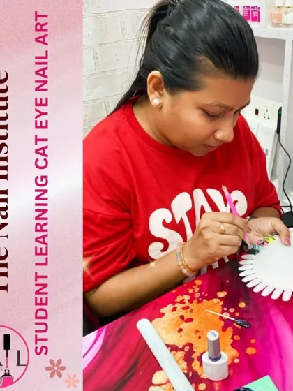 A student practices creating cat eye nail art on a color wheel, experimenting with different base colors.