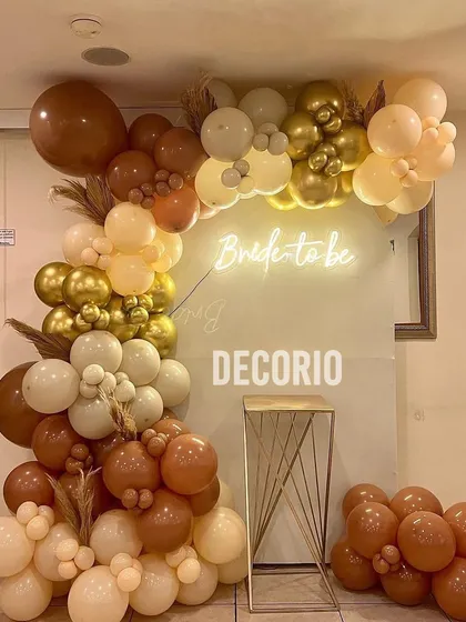 A closer view of the neutral-toned boho bachelorette setup. This style is perfect for an understated and elegant celebration, using a mix of balloon sizes and textures to create a visually interesting organic arch.