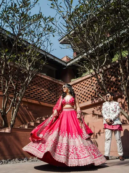 A full view of Shilpi's vibrant pink lehenga for her carnival-themed pre-wedding event. The entire look is fun, modern, and full of energy.