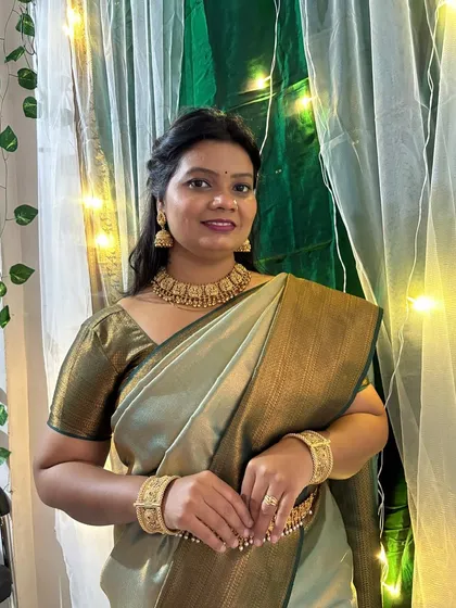 A simple, elegant pose showing the complete temple jewellery set. The choker sits perfectly at the neck, complemented by the matching jhumka earrings.