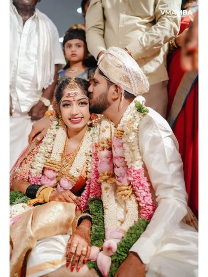 A sweet, candid moment of the groom kissing his bride on the cheek during the wedding ceremony.
