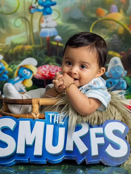 A shy, sweet smile from our little Smurf. The bold logo prop adds another fun element to this creative and playful studio session.