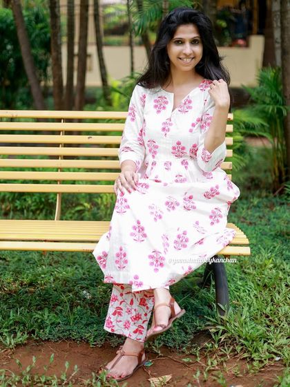Our newly added bestseller, a white and pink printed kurta set. This outfit is perfect to brighten your wardrobe, seen here styled on a park bench.