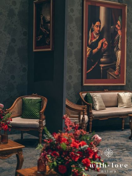 Another perspective of the lounge seating, highlighting the beautiful cane-back chairs and the rich floral arrangements.