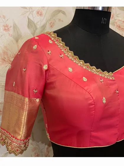 Another view of the red blouse, showing the clean finish and the delicate embroidery that makes it special.