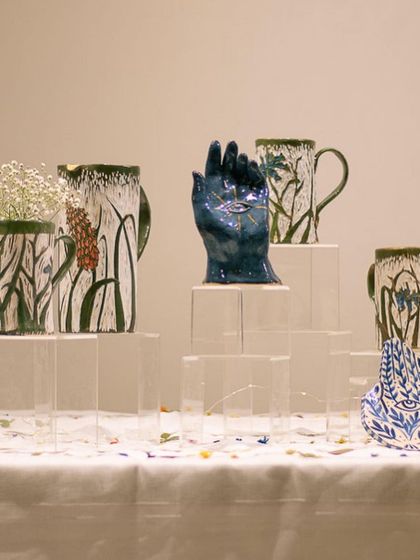 A collection of handcrafted pottery on display at a pop-up event. We love taking our students' work on the road!