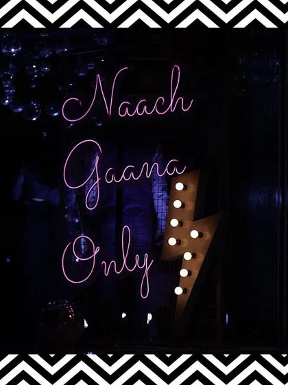 A fun neon sign saying "Naach Gaana Only" that perfectly captured the vibe of the Sangeet night. We love adding these quirky elements.