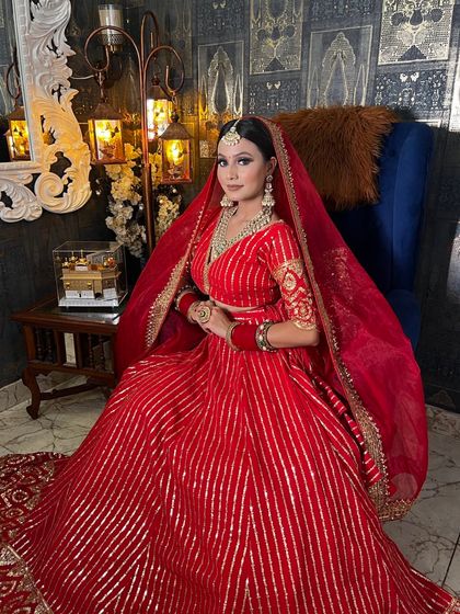 A perfect portrait of a traditional Indian bride. The makeup, jewelry, and outfit all come together to create a look of pure elegance.