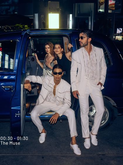 Late to the party, but you've come to steal the show. This image captures the dynamic energy of an arrival, with a group dressed to impress.