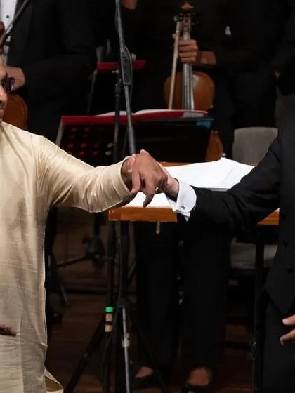 Taking a bow with the conductor, a gesture of mutual respect and shared success.