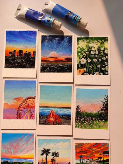 A collection of nine different polaroid paintings, showing the wide range of scenes I can create, from flower fields to beach bonfires.