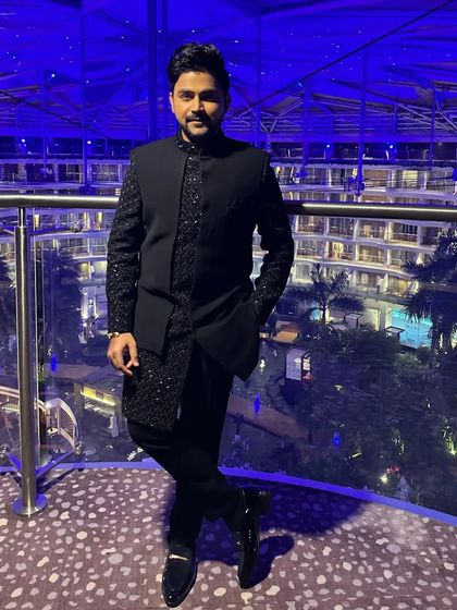 A full-length shot showing how the blue Indo-western outfit is styled. The fit is tailored to be sharp and modern.