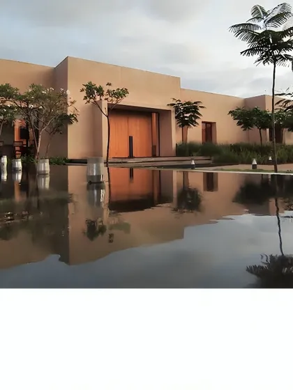 This is Earthsong, an experience center we designed to feel like it grew right out of the land. The minimalist, earth-toned structure is reflected in the water, creating a moment of pause and connection with the environment before you even step inside.