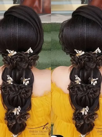 An intricate open hairstyle featuring cascading roses made from the hair itself. This is a very creative and romantic look for a reception or engagement.