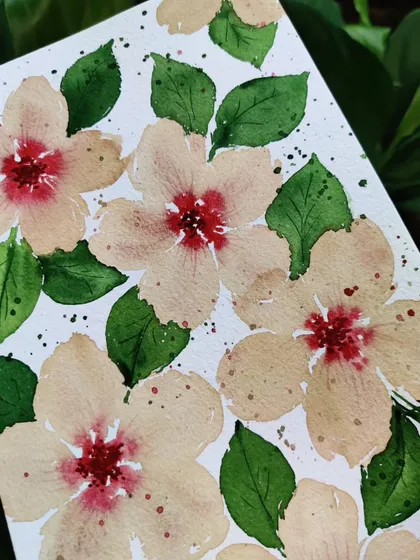 A close up shot of the watercolor flowers. You can see the wet on wet technique in the center, where the red bleeds into the lighter petals.