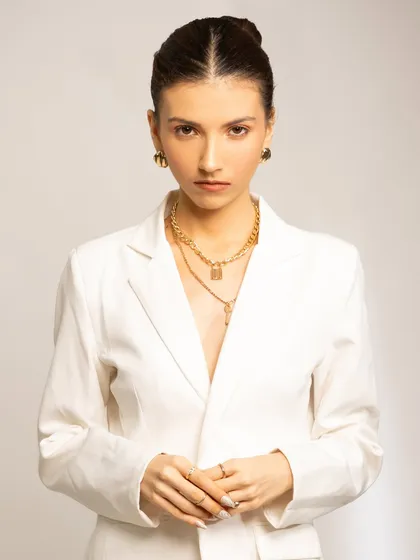 A clean, professional look perfect for a corporate or commercial setting. The makeup is minimal and fresh, with neatly pulled-back hair, conveying a sense of focus and power.