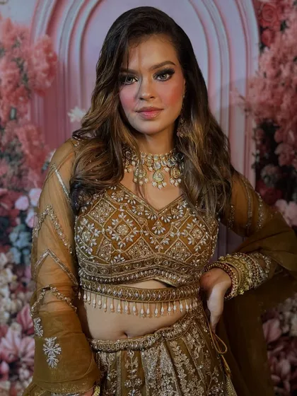 Another angle of this gorgeous party look. The embroidered lehenga is complemented by a bronzed, glowing makeup base and a classic smokey eye, a versatile technique you'll master in my classes.