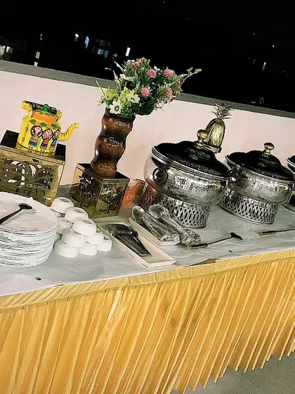 A rooftop buffet setup for 70 guests in DLF Phase 3. The golden decor elements and city-view backdrop make for a sophisticated party setting.