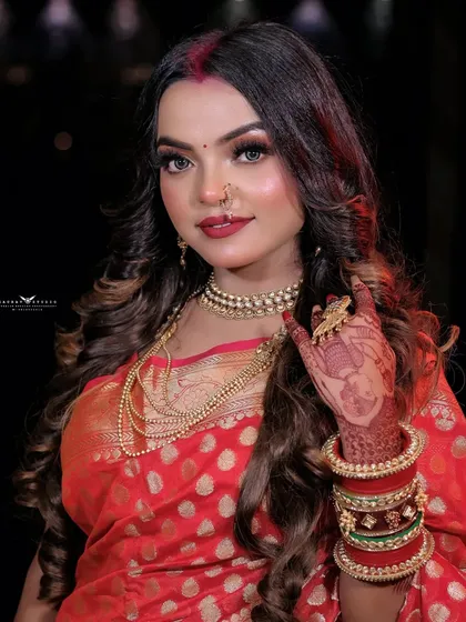 A beautiful portrait of the model, her face illuminated, highlighting her festive makeup and jewelry.