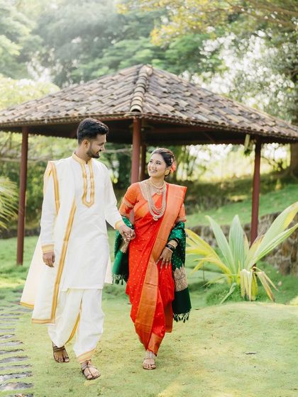 Vicky and Aishwarya take a stroll in the garden, hand in hand. This full-length portrait captures their traditional Maharashtrian attire and the natural, easy-going nature of their relationship.