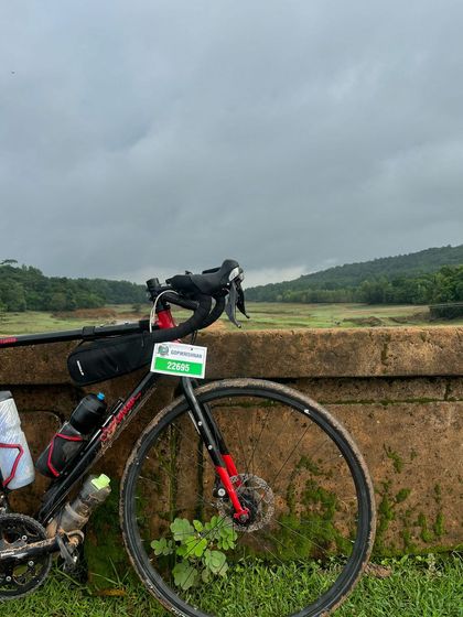 A moment of peace during the grueling Jog Falls 1000K BRM. A rider's bike rests against a bridge, overlooking a serene landscape in the Western Ghats.