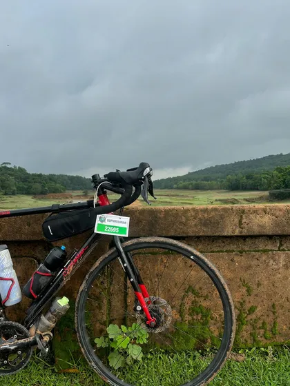 A moment of peace during the grueling Jog Falls 1000K BRM. A rider's bike rests against a bridge, overlooking a serene landscape in the Western Ghats.