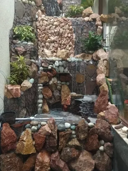 Even a narrow space can accommodate a stunning water feature. I designed and built this vertical stone waterfall to fit perfectly into a wall niche, bringing the sound of water into a compact area.