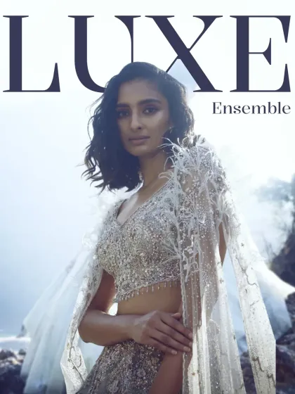 Luxe is in the layers. This image, featuring a stunning embellished lehenga with a feathered cape, introduces our collection of luxe ensembles for the season ahead.
