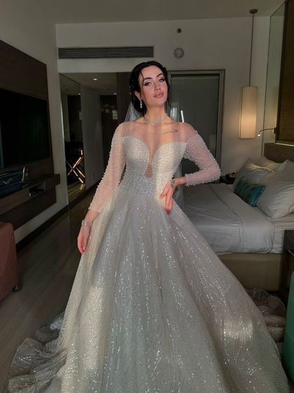 The sparkle of her gown and the glow of her skin create a truly magical bridal moment.