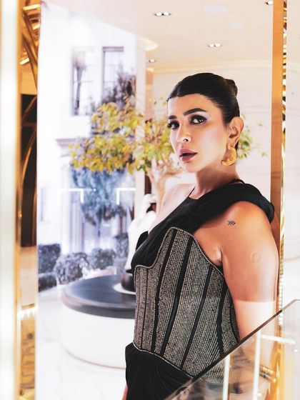 A close-up of the Nexus ensemble, highlighting the texture of the asymmetrical corset belt against the soft satin drape.