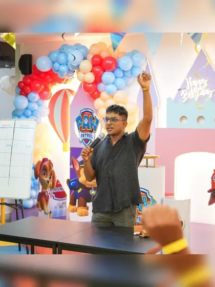 A game host gets the crowd excited during a Paw Patrol themed party. Adding entertainment like this is a great way to make a birthday extra memorable.