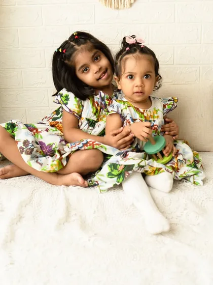 A sweet moment between two sisters during a family photoshoot. I focus on capturing the natural interactions and unique personalities of each child, whether they are posed or playing together.