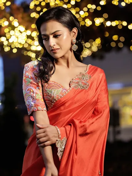 For the 'Daku Maharaj' promotions in Dallas, I styled Shraddha Srinath in this beautiful orange saree. The contrasting embroidered blouse adds a pop of color and intricate detail, making it a radiant and classic choice.