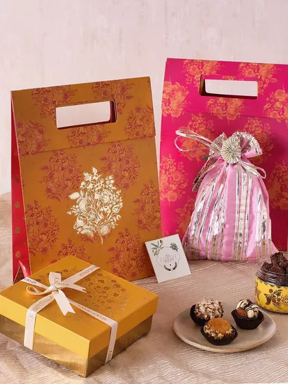 Our festive yellow gift bag is another great option for Diwali gifting, filled with a potli of mini cookies, a jar of fudge brownies, and sugar-free mithai.