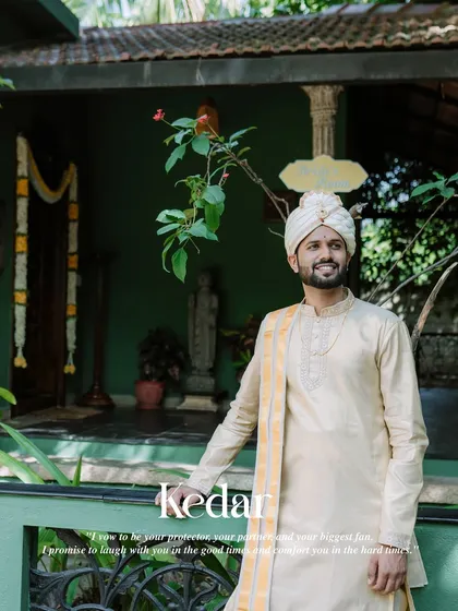 A smiling portrait of the groom in his traditional wedding attire.